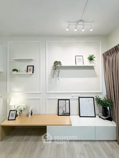 Modern living room with stylish decor and built-in shelving, featuring elegant lighting and natural wood accents.
