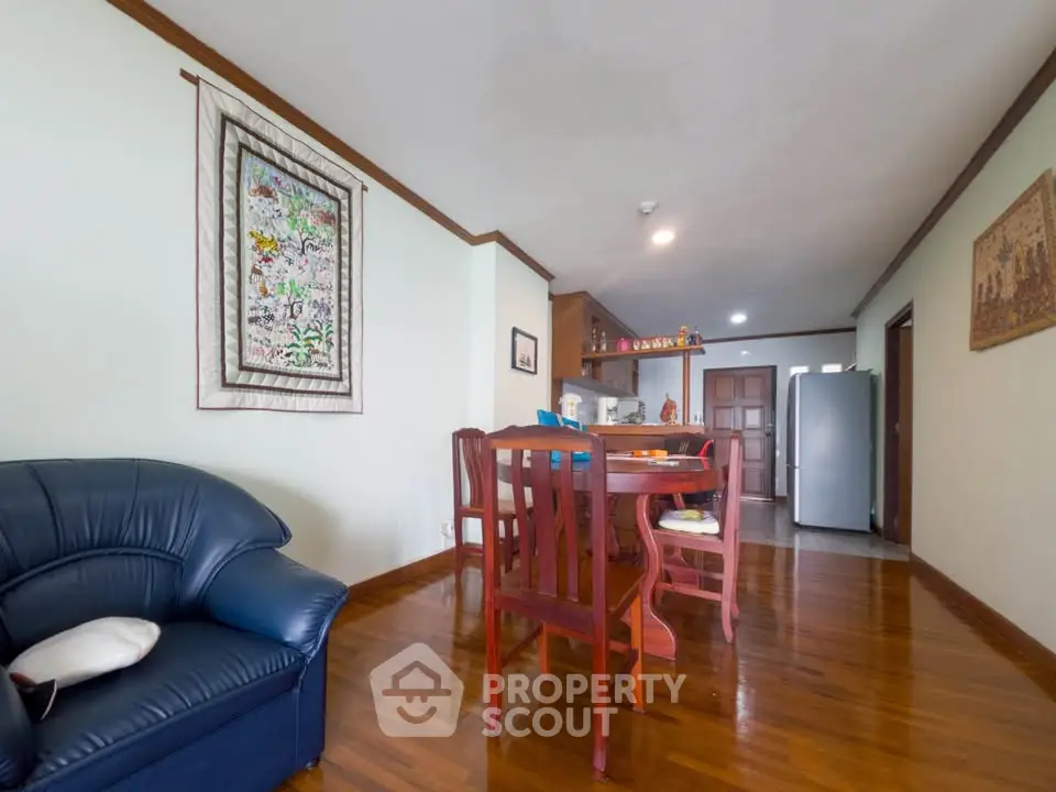 Spacious living room with wooden floors and elegant dining area