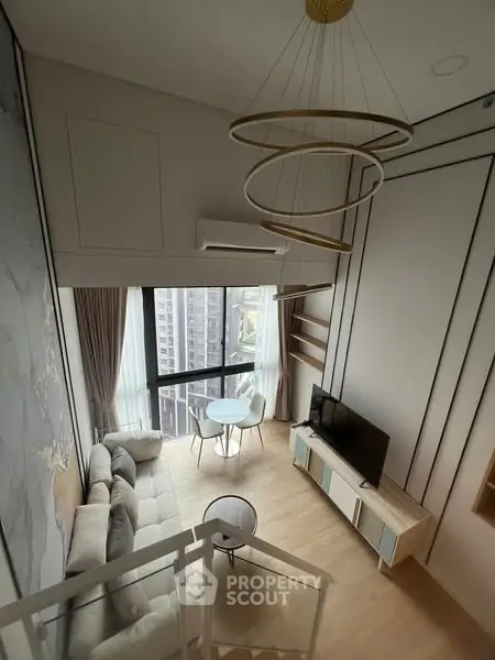 Modern loft-style living room with high ceilings and large windows