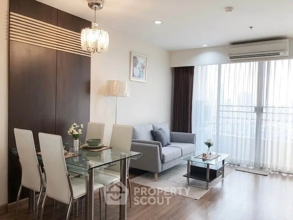 Modern living room with elegant dining area and city view, featuring stylish furniture and natural light.