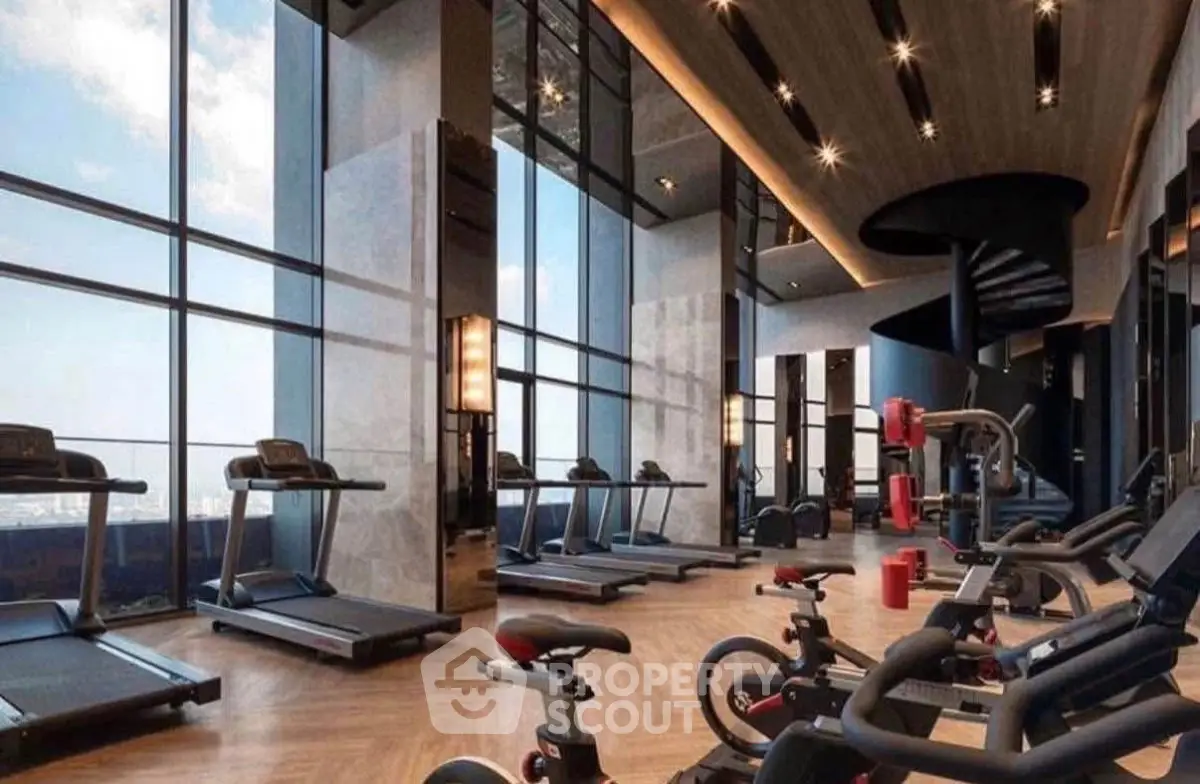 Luxurious high-rise gym with panoramic city views and modern fitness equipment.