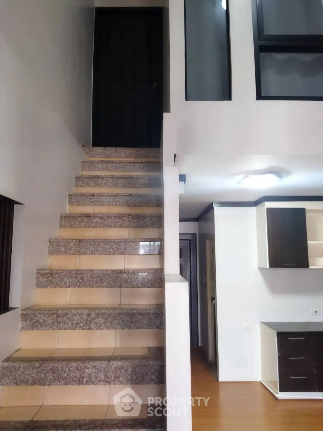 Modern duplex interior with staircase and kitchen area