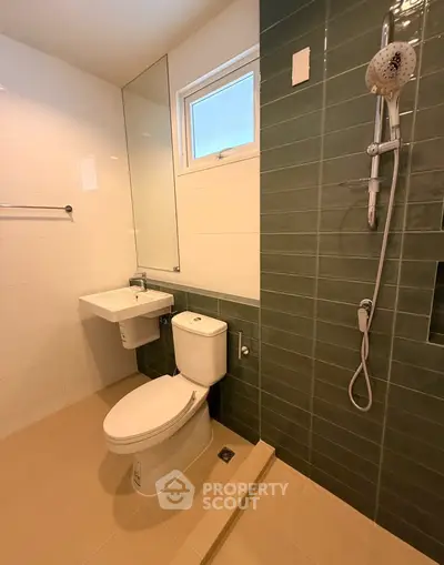Modern bathroom with sleek green tiles and contemporary fixtures