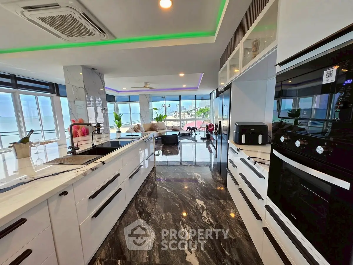 Luxurious modern kitchen with marble flooring and stunning ocean view