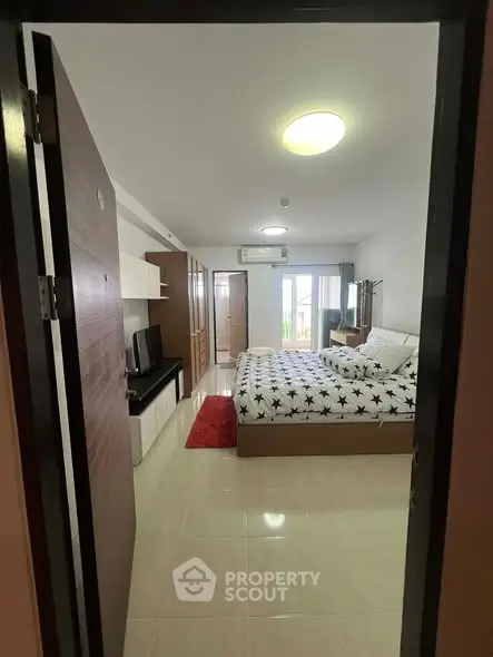 Spacious bedroom with modern decor and ample natural light