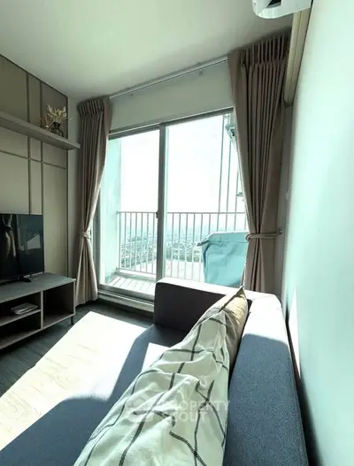 Bright living room with large window and balcony view in modern apartment