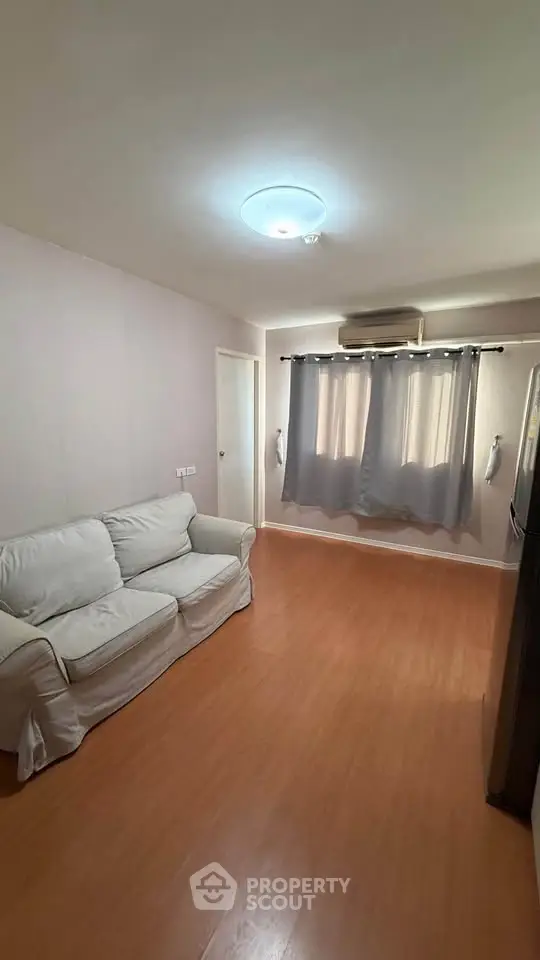 Cozy living room with wooden flooring and natural light
