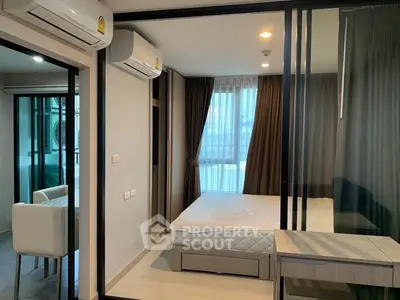 Modern bedroom with large windows and air conditioning in a stylish apartment.