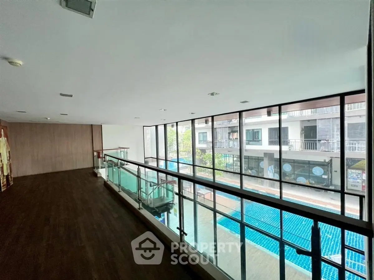 Spacious modern building interior with pool view and large windows