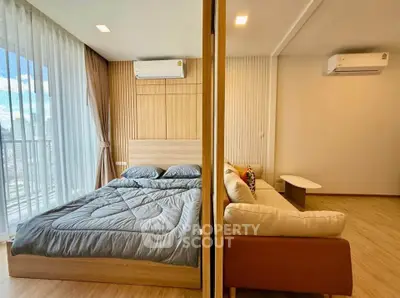 Modern studio apartment with cozy bedroom and living area, featuring wood accents and natural light.
