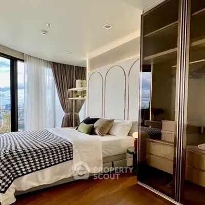 Luxurious bedroom with modern decor and city view, featuring elegant bedding and ample natural light.