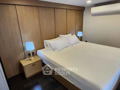 Modern bedroom with wooden accents and cozy lighting