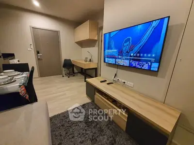 Modern living room with wall-mounted TV and stylish furniture