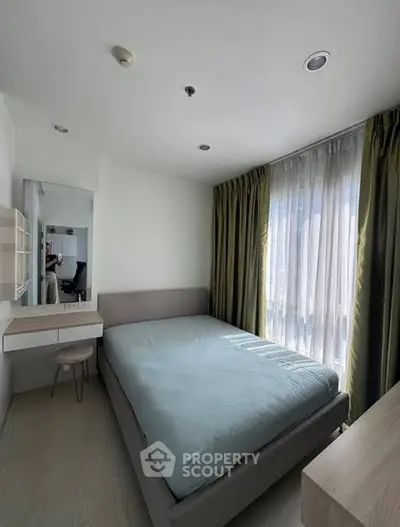 Modern bedroom with natural light and stylish decor in a contemporary apartment.