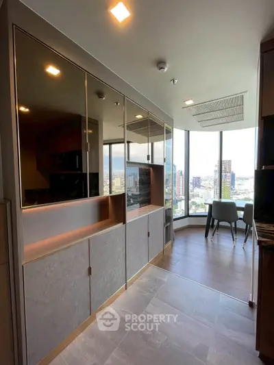 Modern kitchen with sleek cabinetry and stunning city view, perfect for urban living.