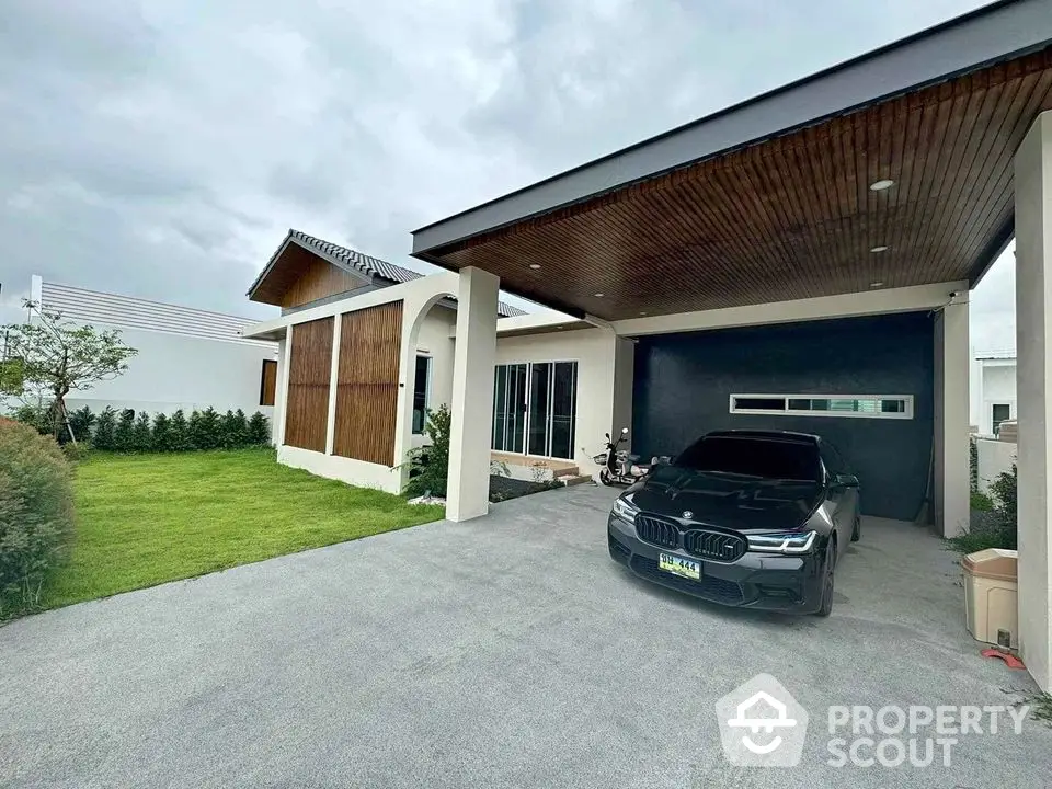 Modern single-story home with sleek carport and lush green lawn