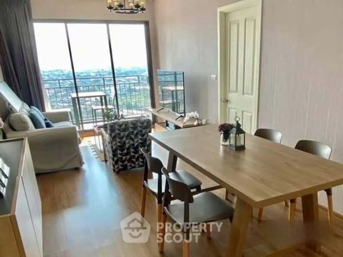 Spacious living room with dining area and balcony view