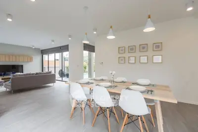 Modern open-plan living and dining area with stylish decor and ample natural light.
