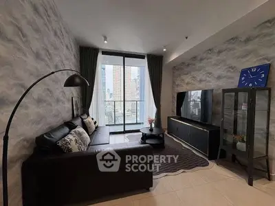 Modern living room with city view, stylish decor, and cozy seating area.