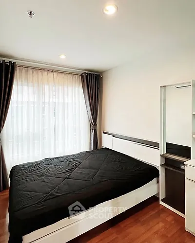 Modern bedroom with large window and sleek furnishings