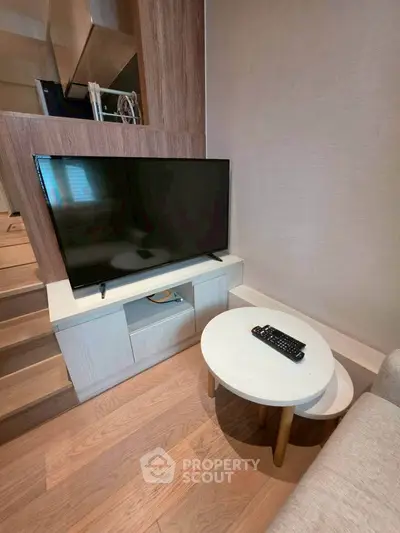 Modern living room with sleek TV setup and stylish wooden flooring
