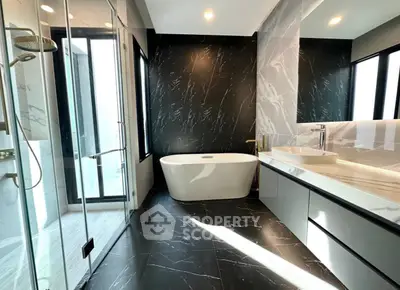 Luxurious modern bathroom with elegant black marble and freestanding bathtub