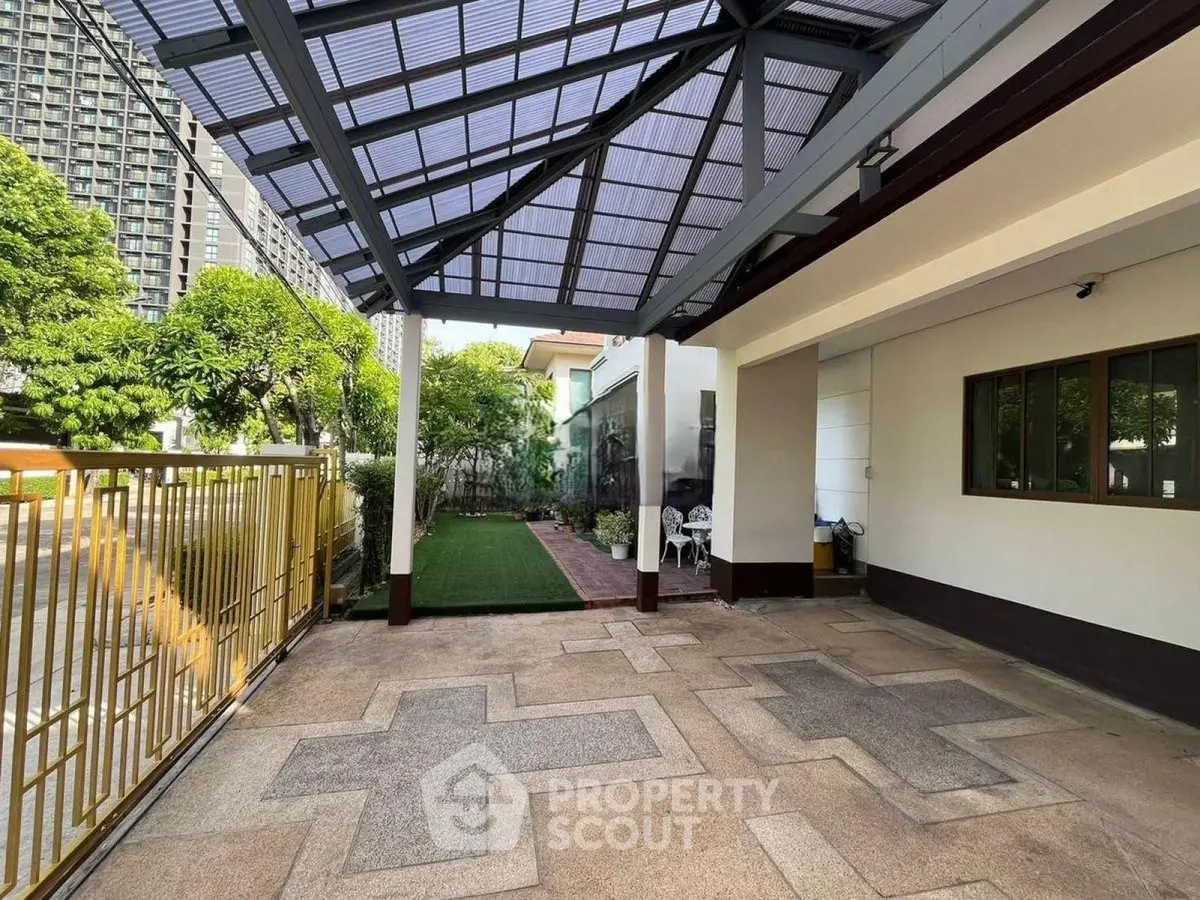 Spacious covered patio with modern design and lush garden view