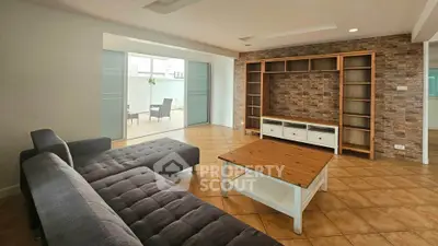Spacious living room with modern furniture and large sliding doors to patio.