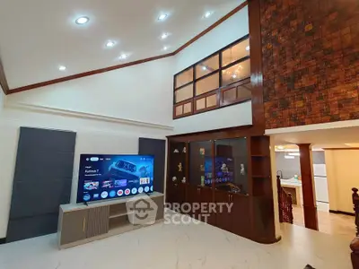 Spacious living room with high ceiling and modern decor