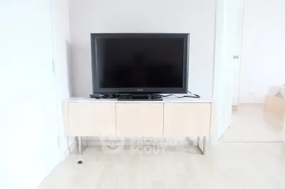 Modern living room with sleek TV stand and flat-screen television