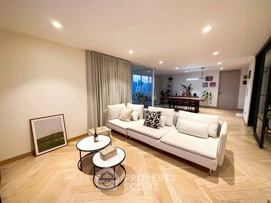 Spacious modern living room with elegant decor and city view, perfect for urban living.