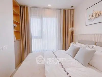 Elegant bedroom with large window and stylish decor