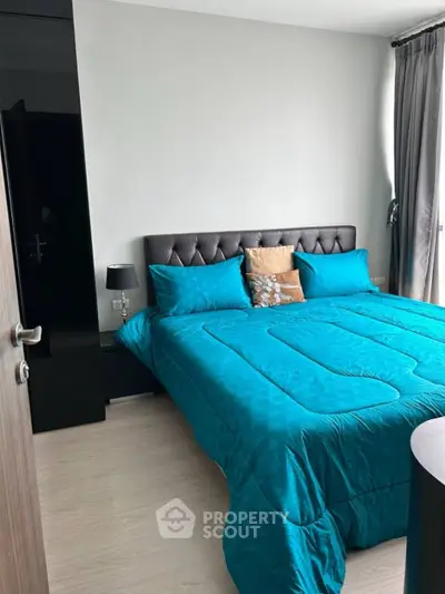 Modern bedroom with teal bedding and elegant decor