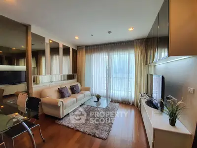 Modern living room with elegant decor, large windows, and cozy seating area in a stylish apartment.