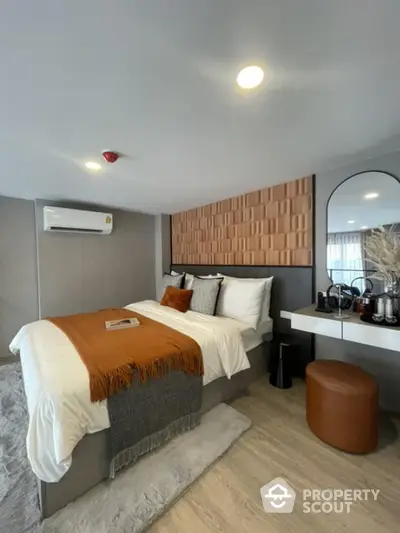 Modern bedroom with stylish decor and cozy ambiance, featuring a comfortable bed and elegant furnishings.