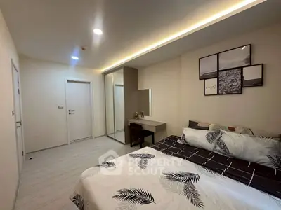 Modern bedroom with stylish decor and mirrored wardrobe in a cozy apartment.
