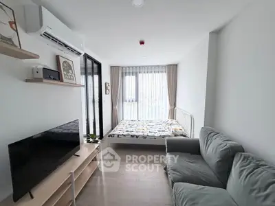Modern studio apartment with cozy living area and natural light