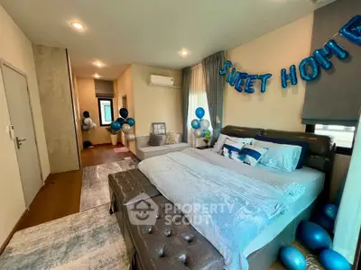 Spacious bedroom with modern decor and cozy ambiance, featuring a comfortable bed and stylish furnishings.