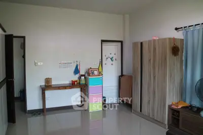 Spacious bedroom with colorful storage and wardrobe, ideal for family living