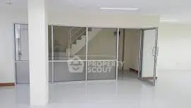 Spacious modern interior with glass partition and staircase