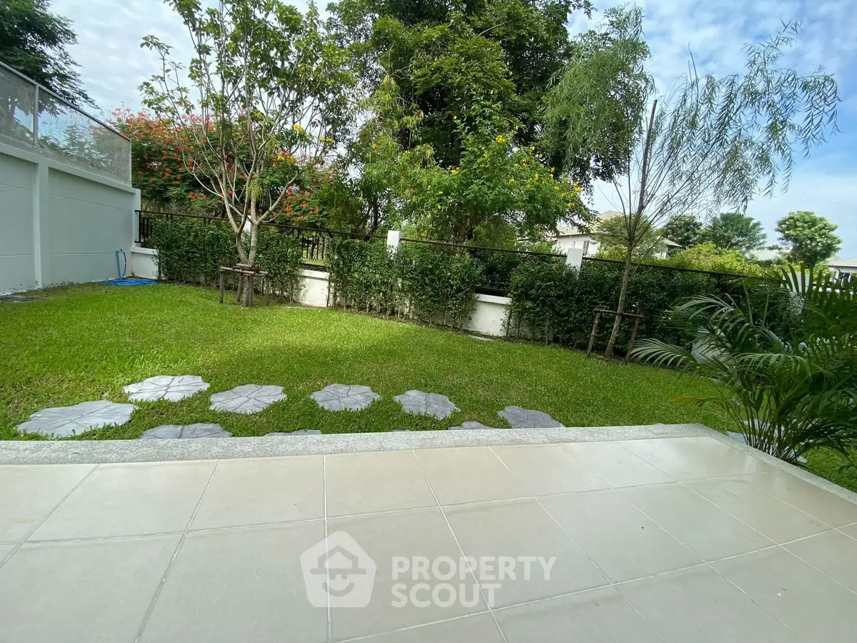 Charming garden view with lush greenery and tiled patio area