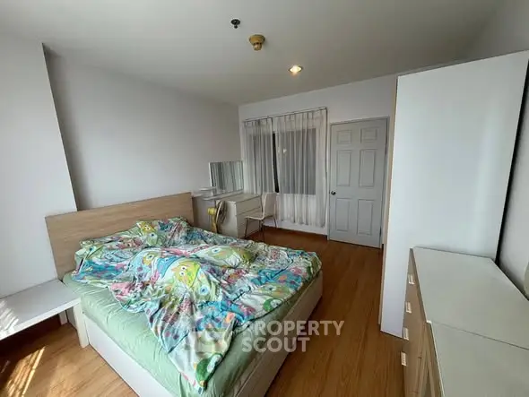 Spacious bedroom with modern furniture and vibrant bedding