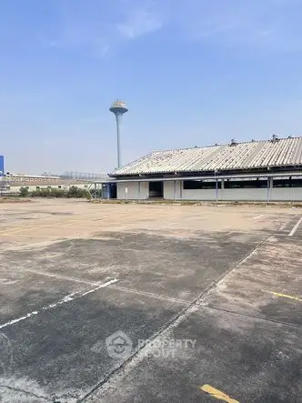Expansive industrial property with large open space and unique architectural features.