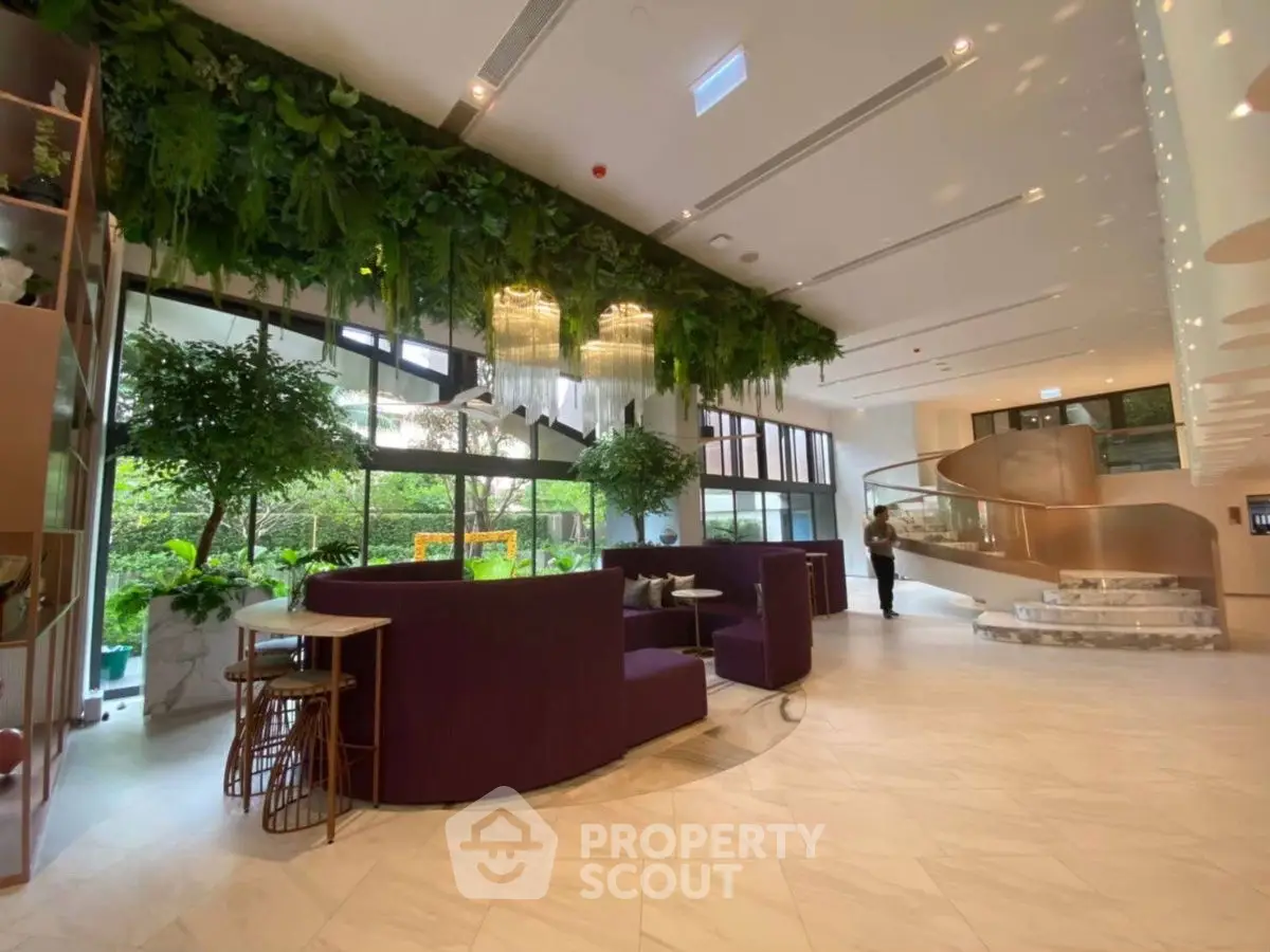 Luxurious modern lobby with lush greenery and elegant seating