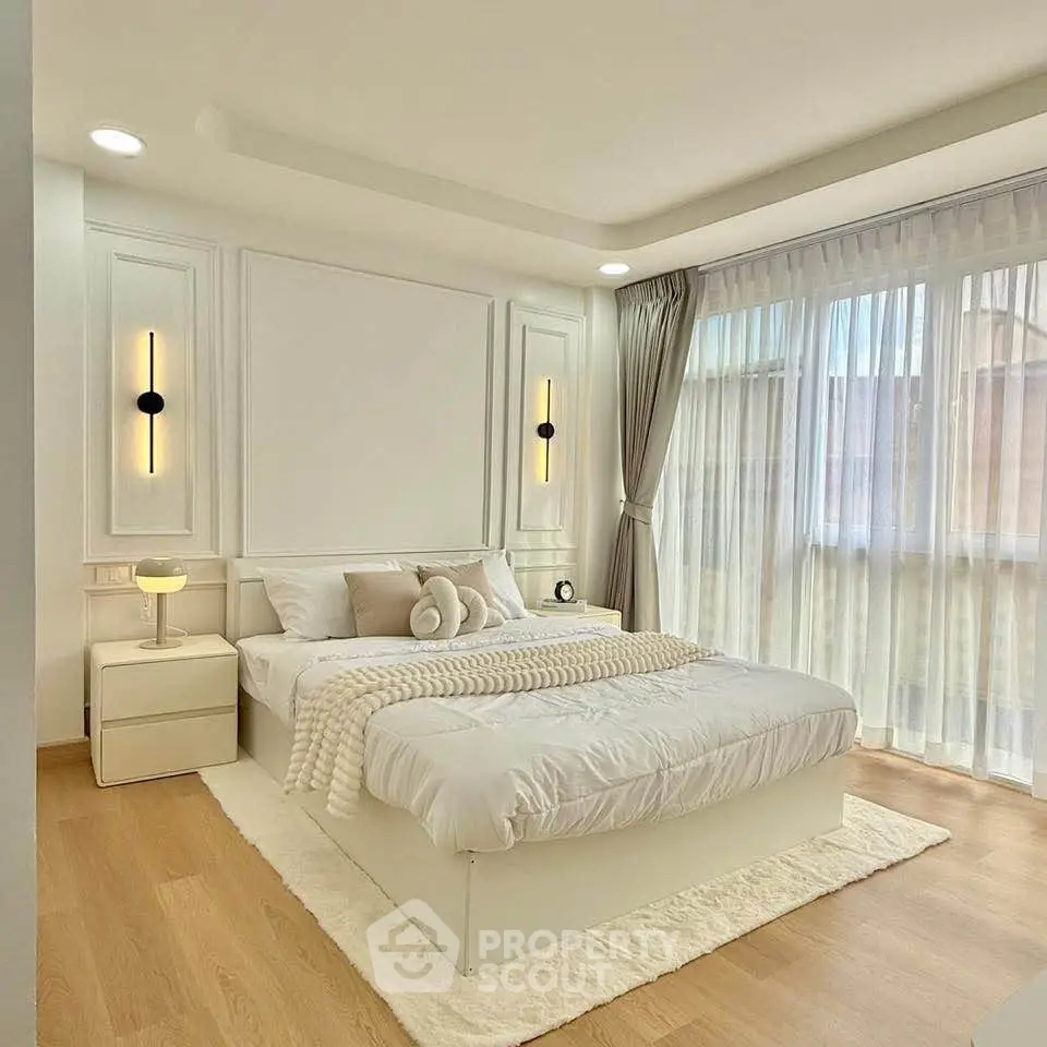 Elegant bedroom with modern decor and large windows for natural light