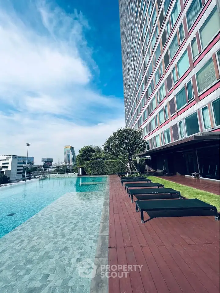 Luxurious high-rise building with stunning poolside view and modern architecture.