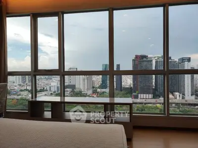 Stunning cityscape view from a modern high-rise apartment window, showcasing urban skyline.
