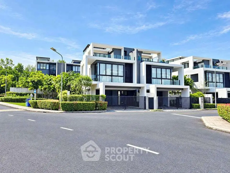 Luxurious modern villa with sleek design and lush greenery in a serene neighborhood.