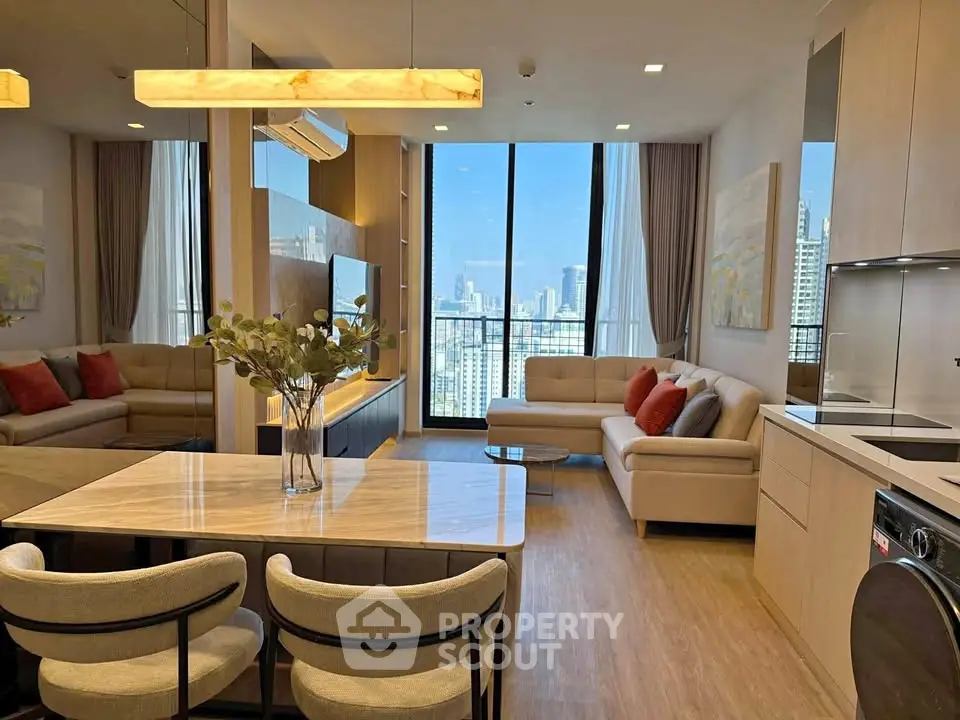 Luxurious modern living room with city view, open kitchen, and elegant decor