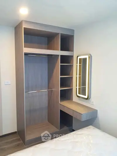 Modern bedroom with built-in wooden wardrobe and illuminated vanity mirror